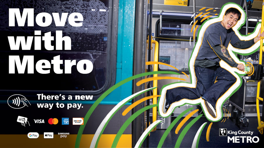 A young man breakdancing while holding out a credit card on a fare reader. 