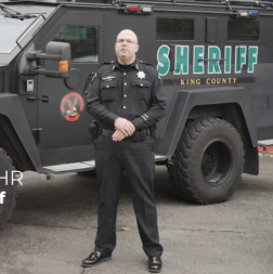 Undersheriff Flohr in front of swat vehicle