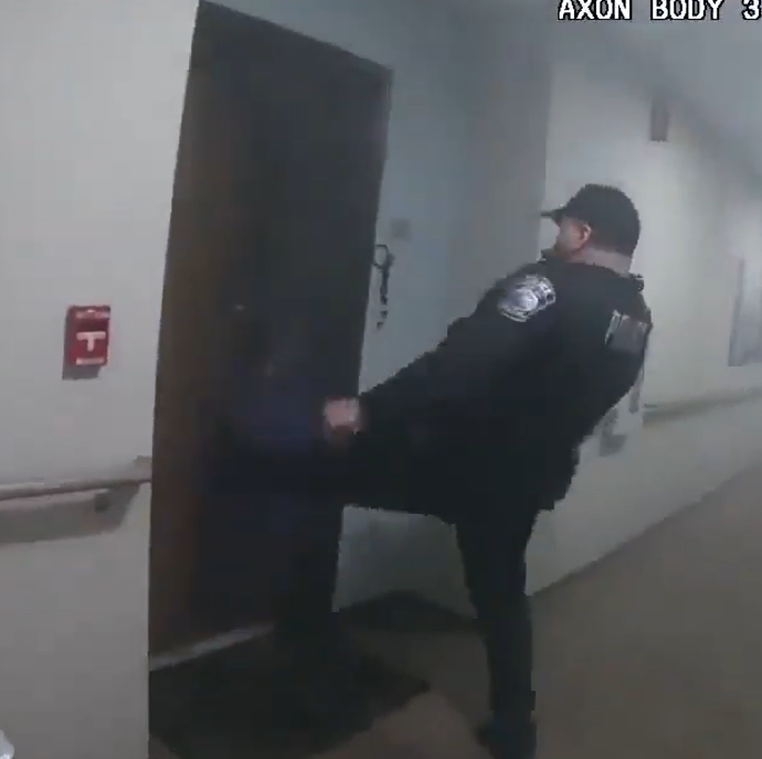 Deputy kicking in a door at apartment building to evacuate