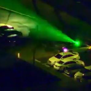 Green laser from car pointing at Guardian 1