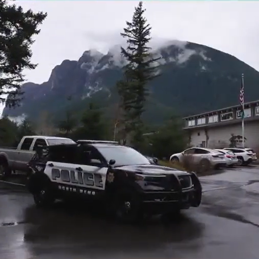 North bend patrol vehicle in front of building and mountain