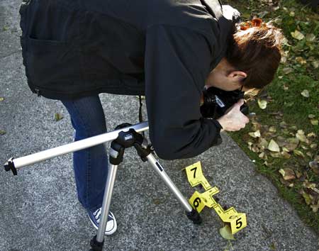 Image of person photographing crime scene