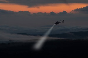 Helicopter with searchlight at dusk