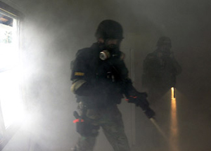 deputy with gas mask in smokey building