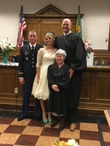 Photo of Judge O'Donnell with a happy couple after performing a wedding ceremony.