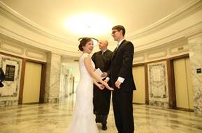 Photo of Judge O'Donnell performing a wedding ceremony for a happy couple.