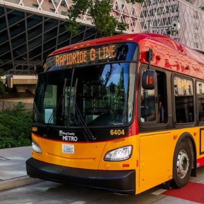 Red and yellow RapidRide G Line bus outside the Seattle Public Library