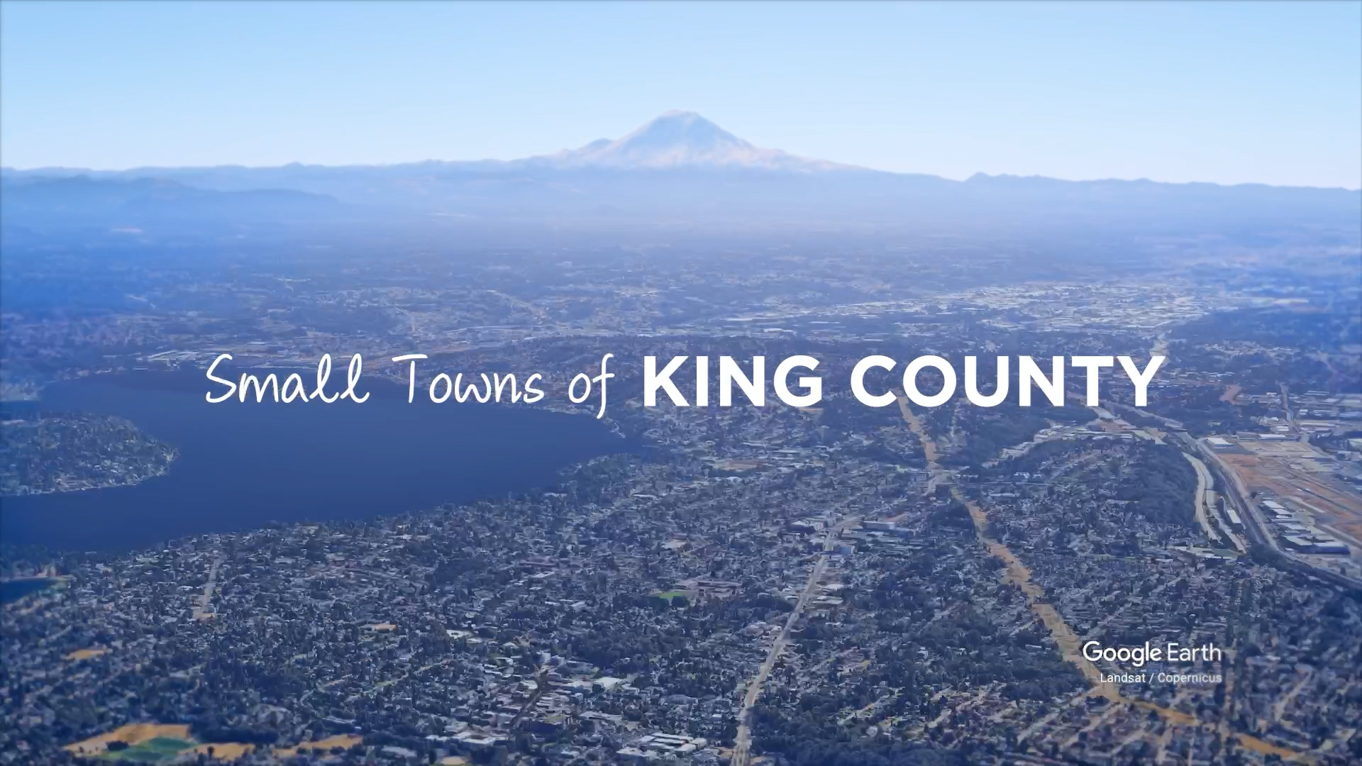 Wide shot of King County with Mt. Rainier in the background. Text says "Small Towns of King County".