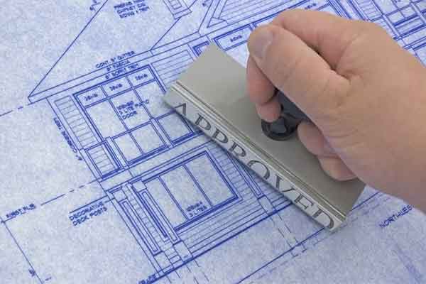 Hand stamping blueprints as approved