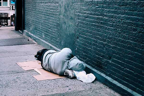Image of person sleeping on sidewalk
