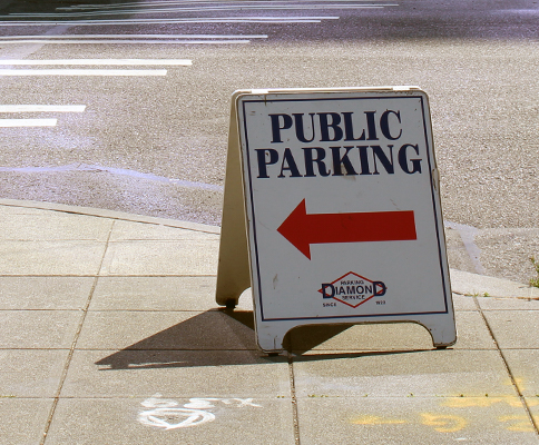 Sign pointing toward public parking.