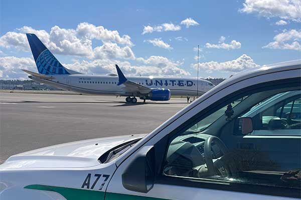 Image of plane flying low over the Georgetown neighborhood of Seattle