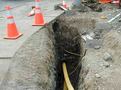 A trench in the right-of-way for underground utility lines and cables.