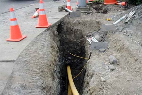 A trench in the right-of-way for underground utility lines and cables.