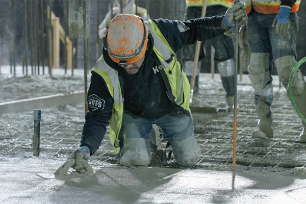 Construction worker smoothing cement